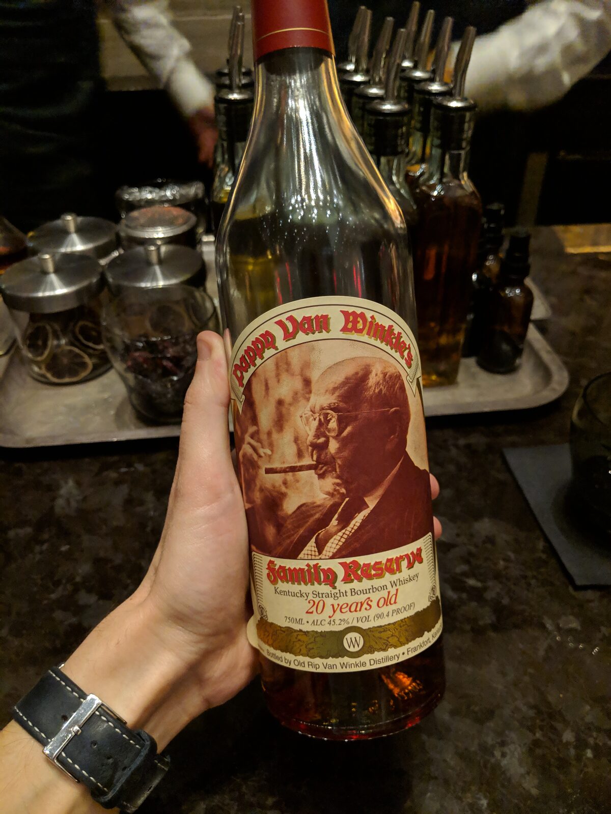 A bottle of Pappy Van Winkle's Family Reserve 20 year bourbon held at a hotel bar