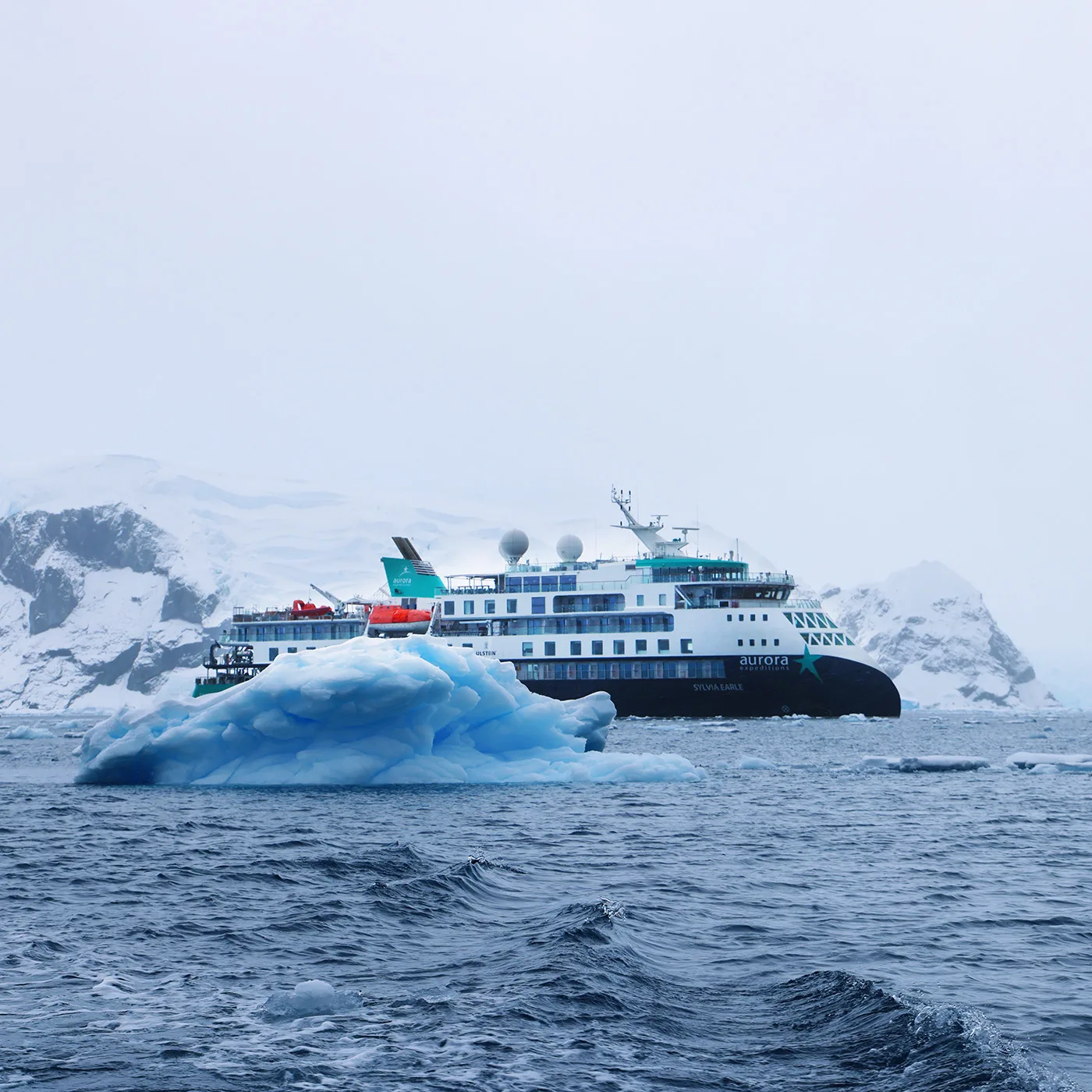 Expedition ship beside an iceberg