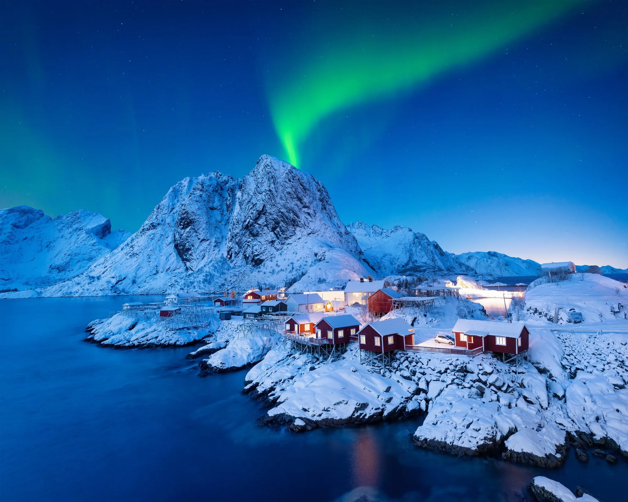 Coastal village beneath the northern lights
