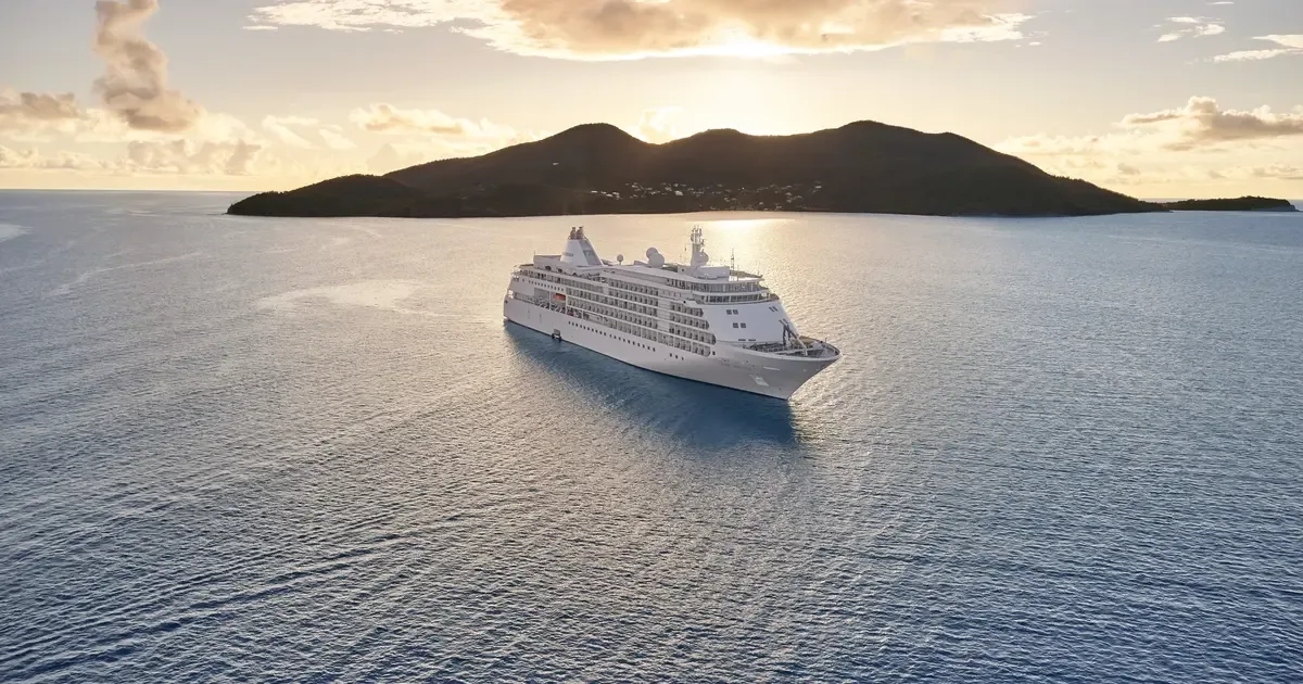 Ship near an island at sunrise