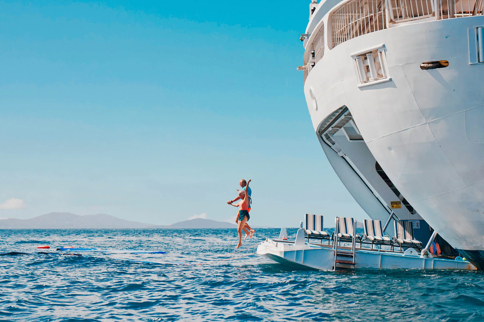 Paddleboarder beside a ship's bow